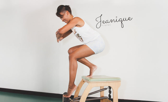 woman standing on Pilates Chair