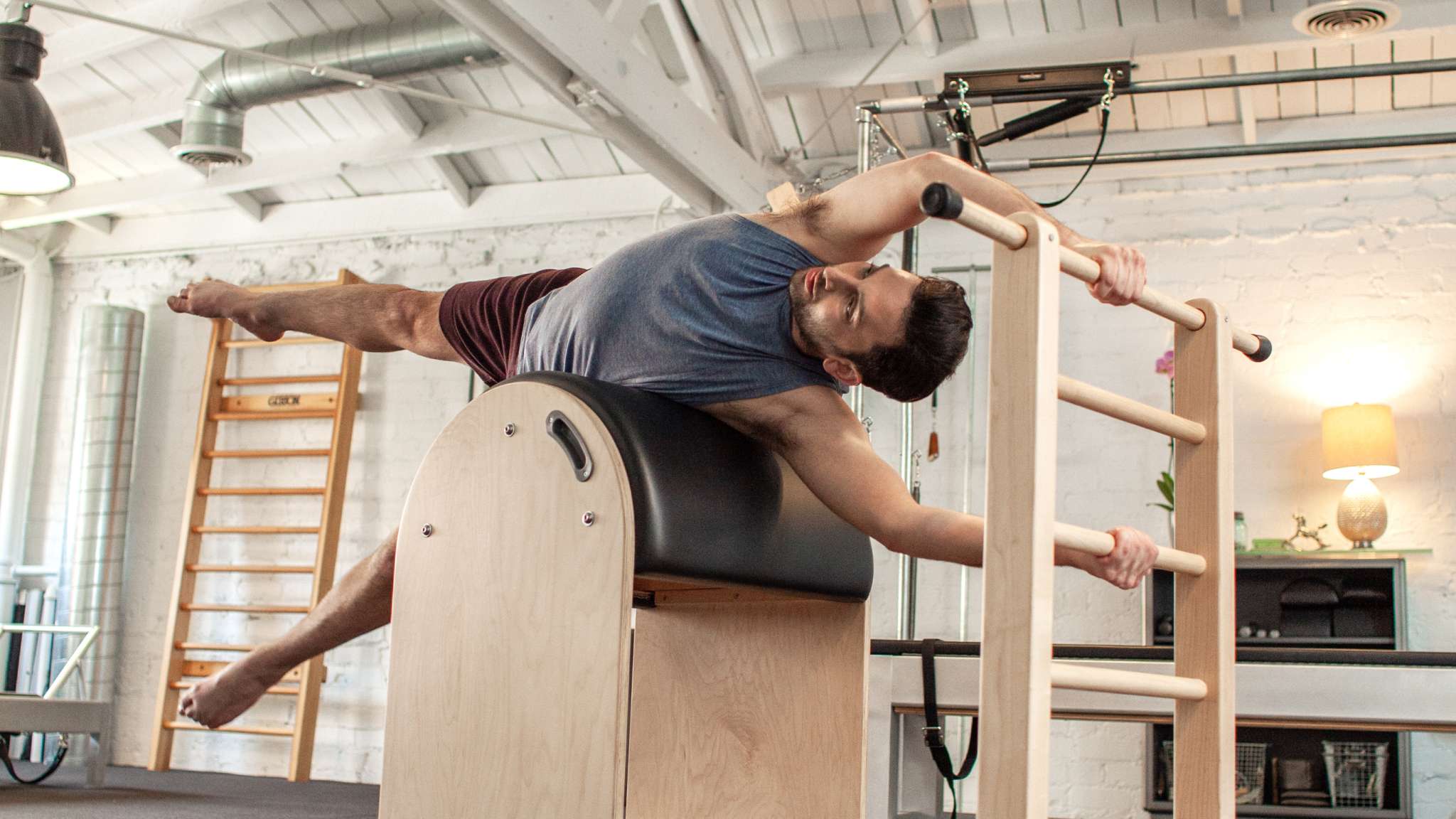 man on his side on ladder barrel