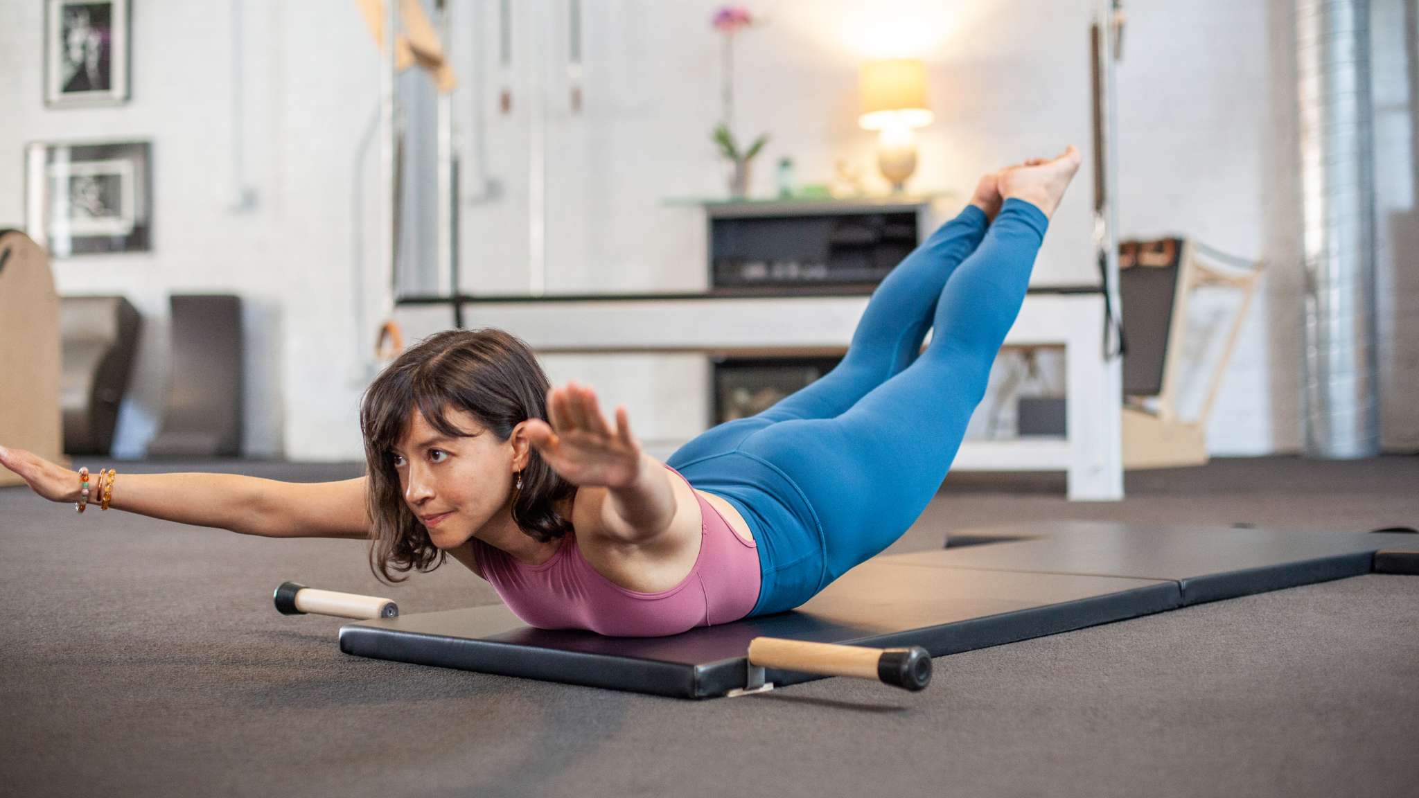 woman doing swan on folding mat