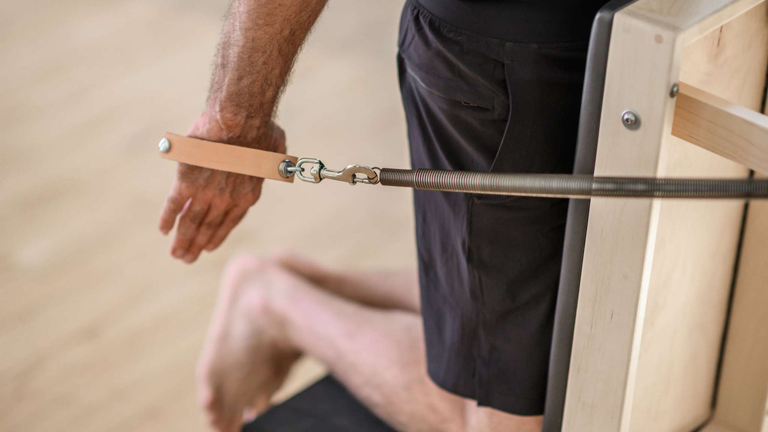 person using arm chair handles