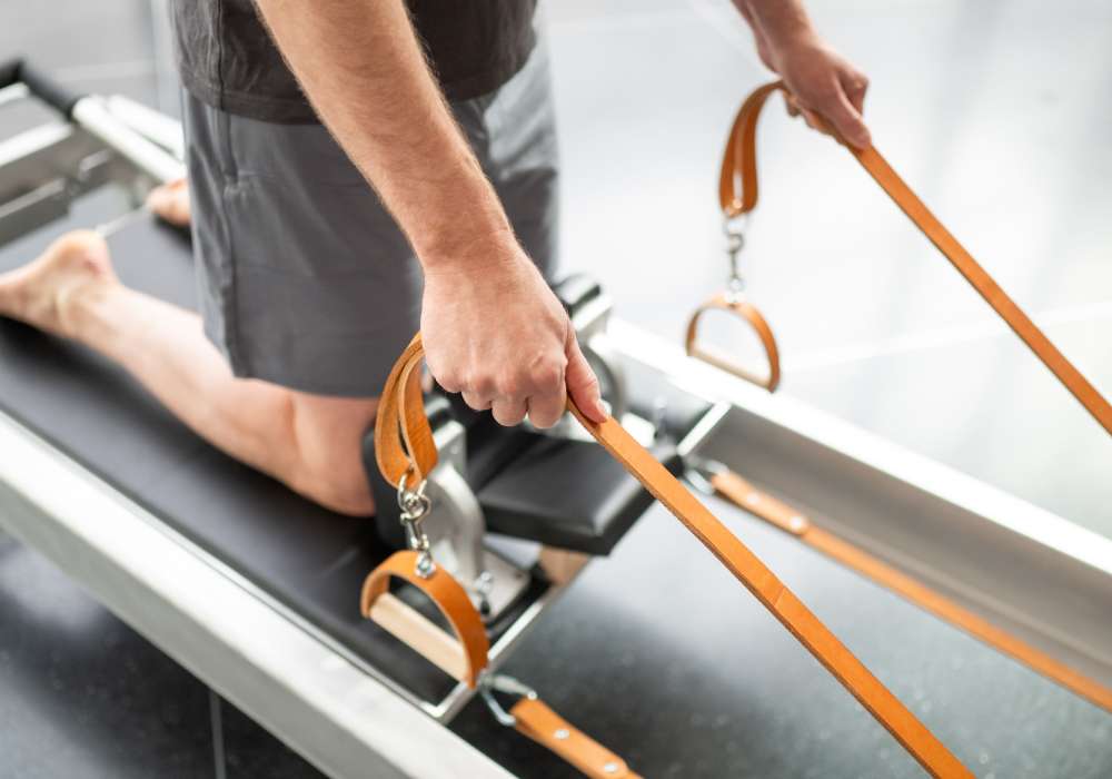 person holding reformer straps