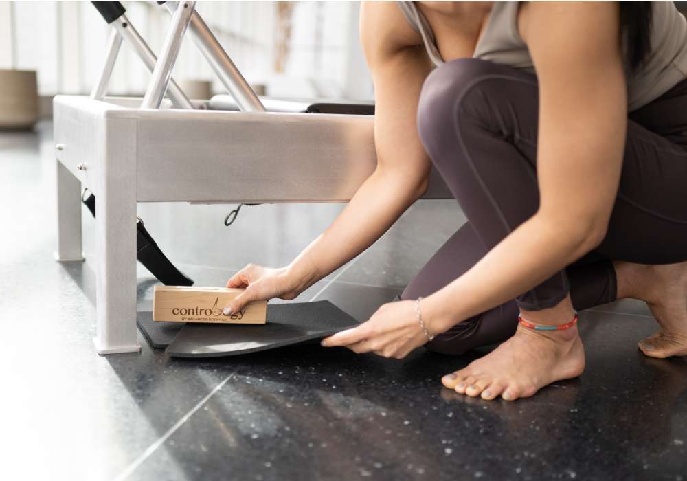 kneeling at the contrology reformer