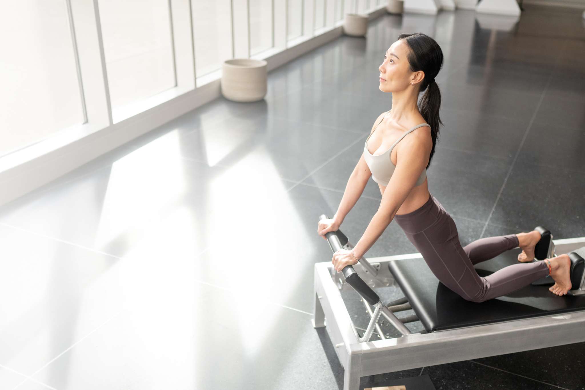 woman using contrology reformer