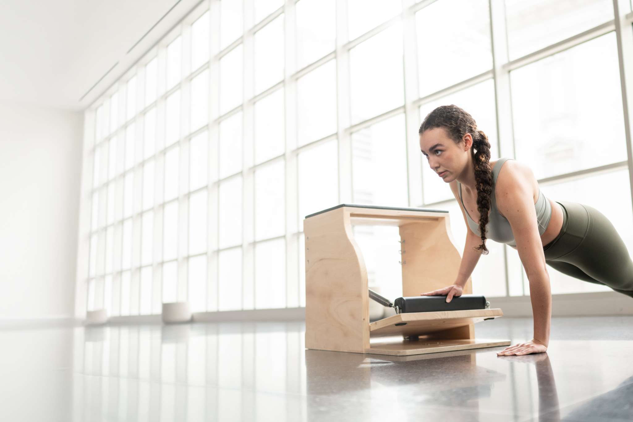 woman using the pedal of a pilates chair