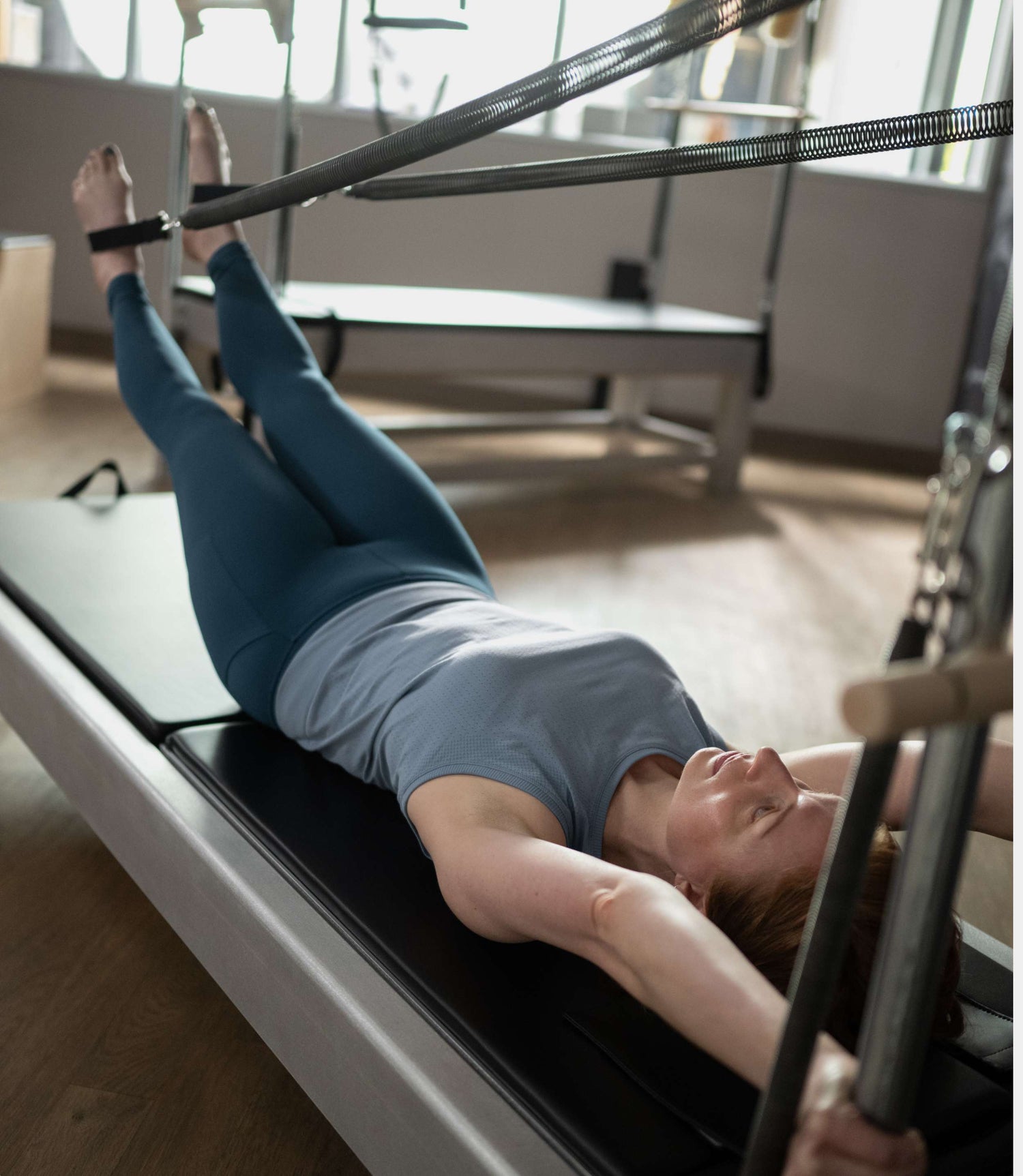 Contrology Reformer with Tower and Mat - in use